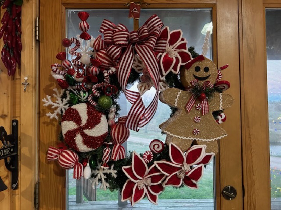 Candy-themed Christmas wreath with gingerbread, peppermint and striped ribbon